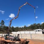 Cement being piped into new range wall